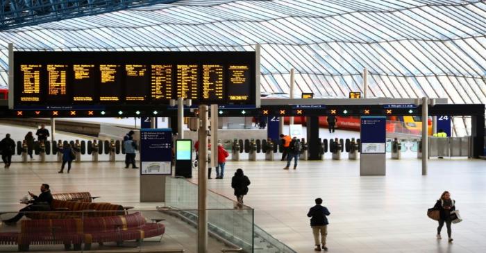 Commuters walk through Waterloo station during rush hour, as the number of Coronavirus cases