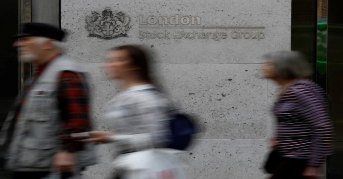 FILE PHOTO: People walk past the entrance of the London Stock Exchange in London