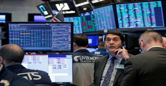 FILE PHOTO: Traders work on the floor of the NYSE in New York