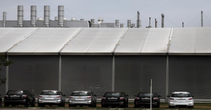 Cars are pictured at the General Motors Co plant, that will give time off to its employees