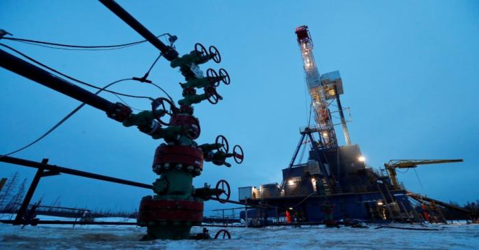 FILE PHOTO: A well head and drilling rig in the Yarakta oilfield in Russia