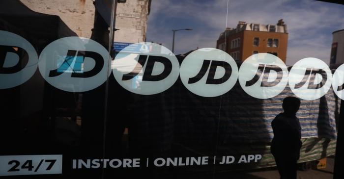 People pass a JD Sports store in London