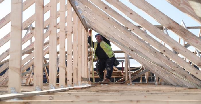 FILE PHOTO:  A builder working for Taylor Wimpey builds a roof on an estate in Aylesbury