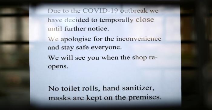 FILE PHOTO: A sign is seen on the front of a shop informing customers it is closed due to the
