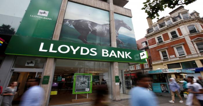 FILE PHOTO:  People walk past a branch of Lloyds Bank on Oxford Street in London