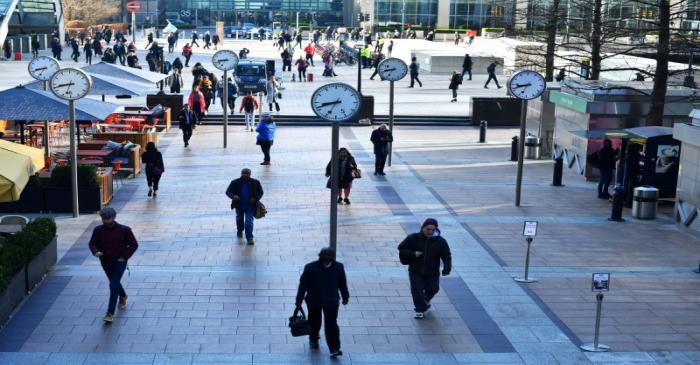 FILE PHOTO:  Commuters walk through Canary Wharf in London