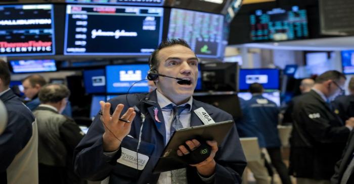 FILE PHOTO: Traders work on the floor of the NYSE in New York
