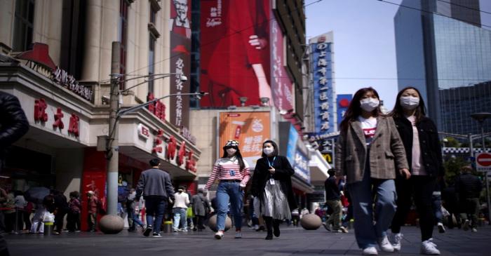 People wear masks at a main shopping area after the city's emergency alert level for