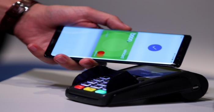 FILE PHOTO: An employee of Wirecard AG, presents the contactless payment system 