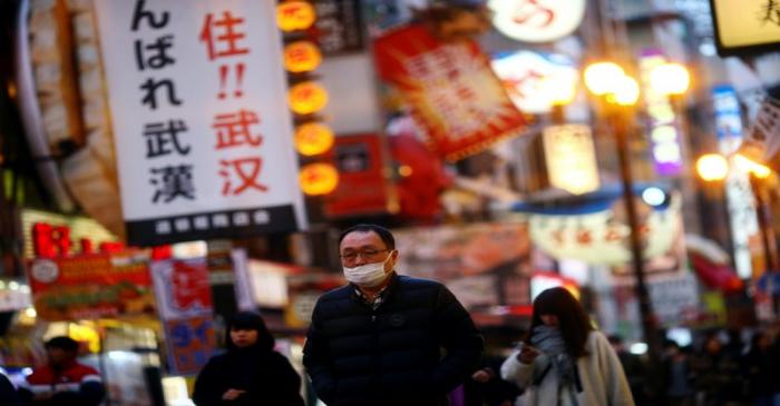 FILE PHOTO: A man, wearing protective mask following an outbreak of the coronavirus disease