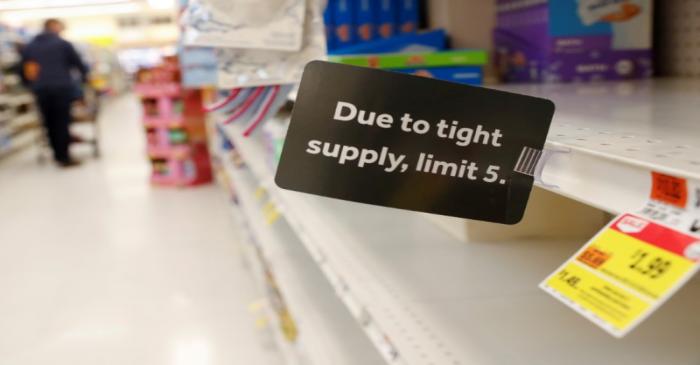 FILE PHOTO: A sign is seen posted on shelves, after further cases of coronavirus were confirmed