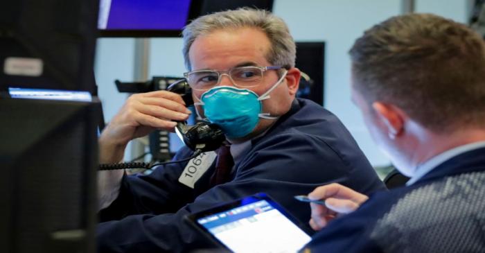 FILE PHOTO: A trader wears a face mask on the floor  of the NYSE in New York