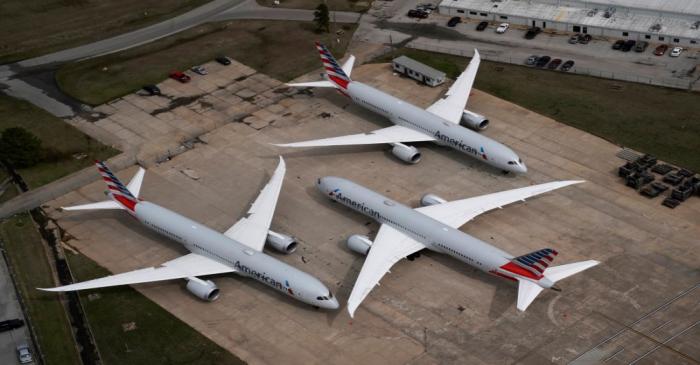 American Airlines passenger planes crowd a runway where they are parked due to flight