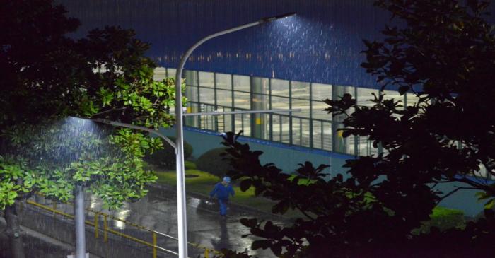 Worker walks past a factory after the production line resumed, following the novel coronavirus