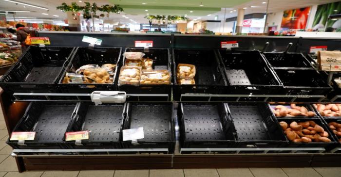 FILE PHOTO: Partially emptied shelves are pictured at a Rewe grocery store in Potsdam