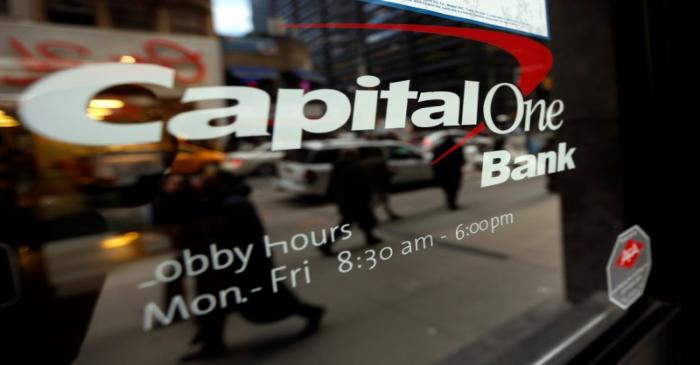 FILE PHOTO: People walk past a Capital One banking center in New York's financial district