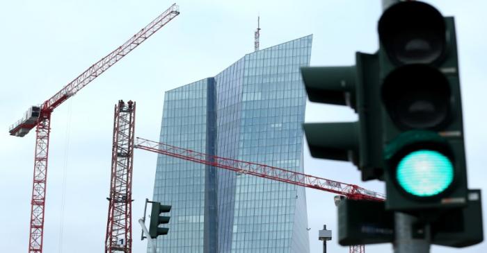 FILE PHOTO: Specialists work on a crane in front of the European Central Bank (ECB) in