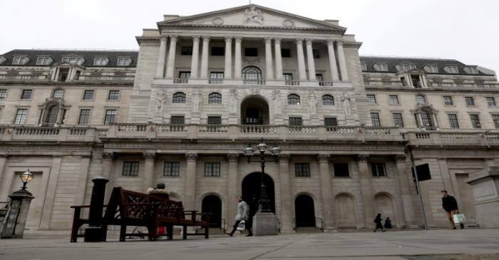 FILE PHOTO: People walk in front of the Bank of England, as the number of coronavirus disease