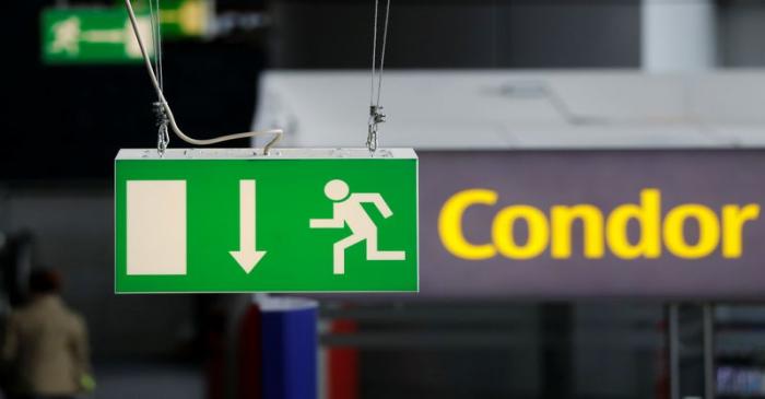 FILE PHOTO:  An emergency exit sign is seen next to the logo of airline Condor at the airport 
