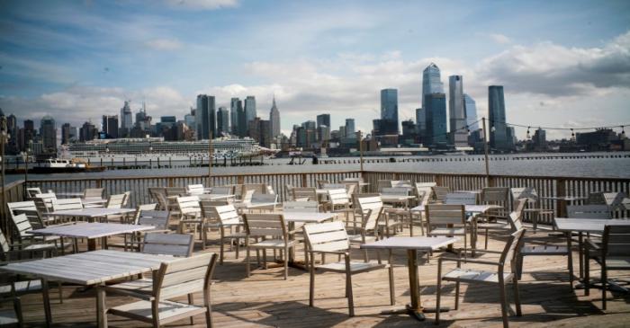 FILE PHOTO: Empty chairs are seen at the deck of a local restaurant that is closed due to the