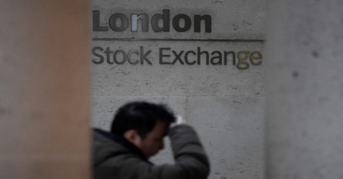 People walk past the London Stock Exchange Group offices in the City of London, Britain