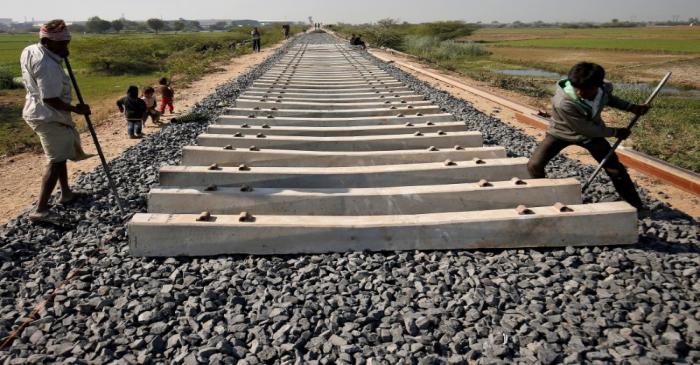 FILE PHOTO: Labourers build a new railway track on the outskirts of Ahmedabad