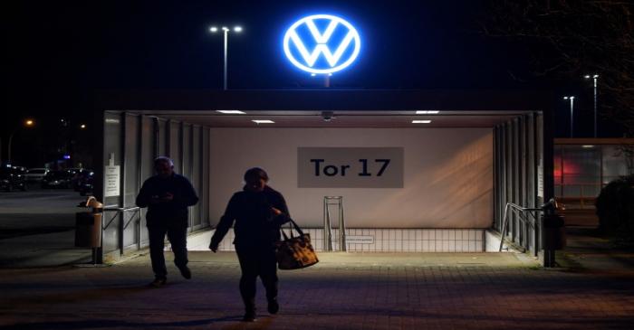 Employees leave the Volkswagen plant after VW starts shutting down production in Europe amid