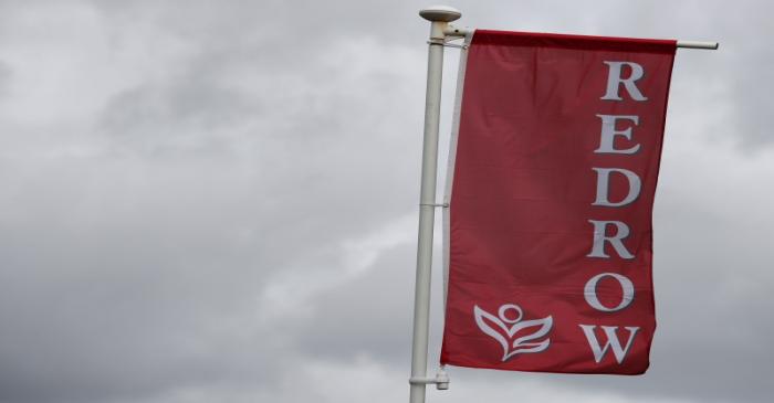 The company logo of construction company Redrow is pictured on a flag at a new housing