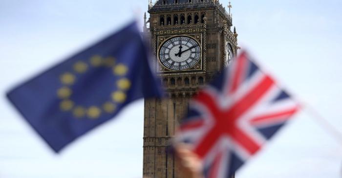 Participants hold a British Union flag and an EU flag during a pro-EU referendum event at