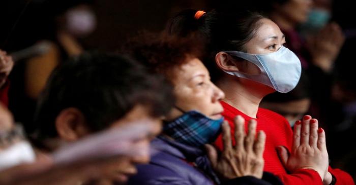 Devotees wear protective face masks while praying at Lungshan Temple in Taipei