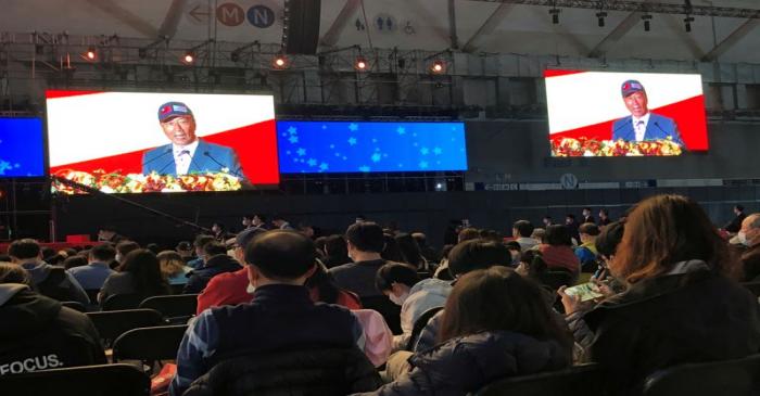 FILE PHOTO: Screen shows Foxconn founder Terry Gou giving a speech as employees wearing masks