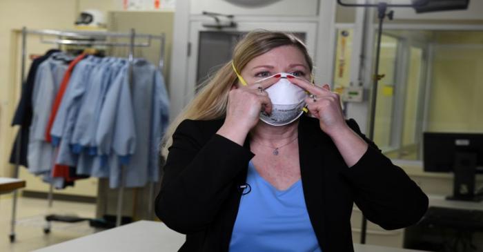 FILE PHOTO: Dr. Nicole McCullough, a global health and safety expert at 3M, demonstrates the