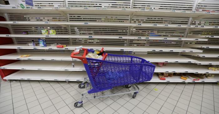 A view shows empty shelves at a Carrefour supermarket as people began stockpiling food in