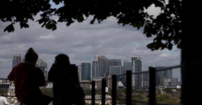 The Canary Wharf financial district stands beyond the Greenwich Maritime Museum in London