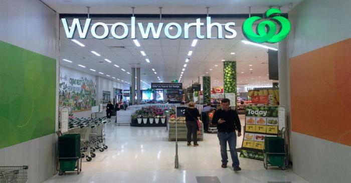 FILE PHOTO: A shopper walks out of a Woolworths store in Sydney, Australia