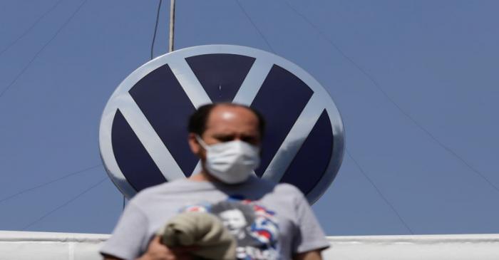 An employee leaves the Volkswagen (VW) plant as the company will temporarily close its