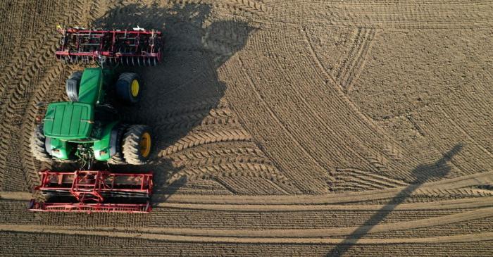 FILE PHOTO: A French farmer drives his tractor to prepare the land before sugar beets sowing in