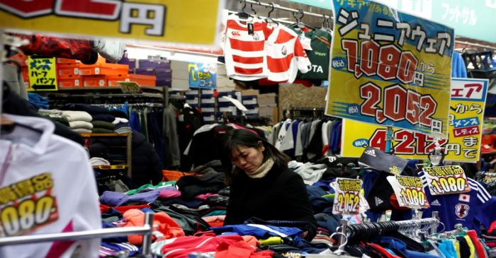 FILE PHOTO: A woman chooses clothes at a shop in Tokyo