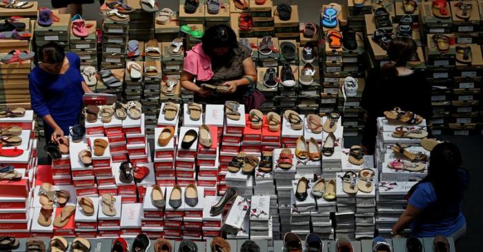 People shop for shoes at a a mall in Singapore