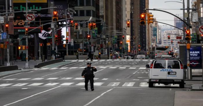 A New York City Police officer (NYPD) takes a selfie while in the middle of the street in an