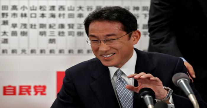Japan's ruling Liberal Democratic Party policy chief Fumio Kishida smiles as he speaks with the