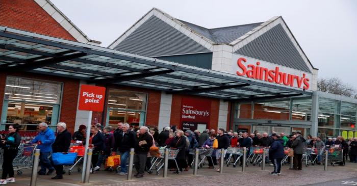 FILE PHOTO: Elderly people wait for a Sainsburys supermarket in Hertford to open