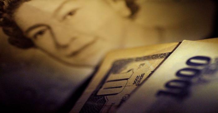 Illustration photo of Japan Yen note in front of U.S. Dollar and British Pound Sterling notes