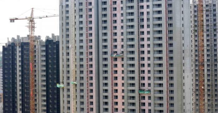 FILE PHOTO: Workers are seen at a construction site of residential buildings in Qingzhou