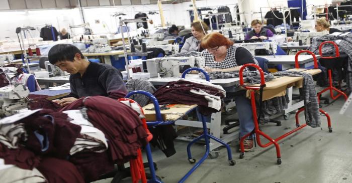 FILE PHOTO: Employees work on sewing machines at the Fashion Enter factory in London
