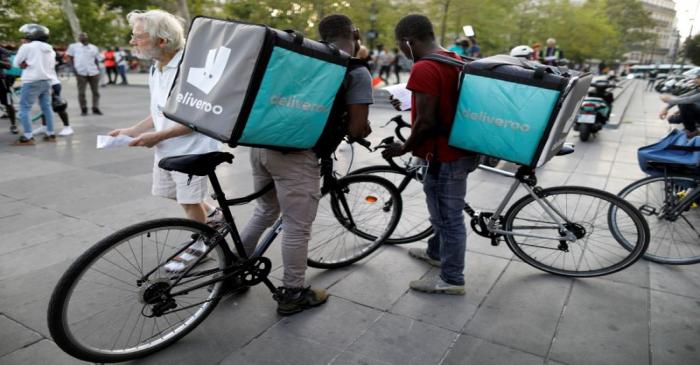 FILE PHOTO: Bikers of food courier service Deliveroo demonstrate as they called on clients to