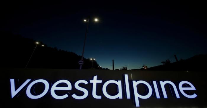 FILE PHOTO: An illuminated logo of steelmaker Voestalpine stands in front of the steel plant