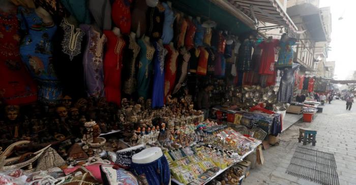 A shopkeeper waits for customers at a souvenir shop at a popular tourist area named 