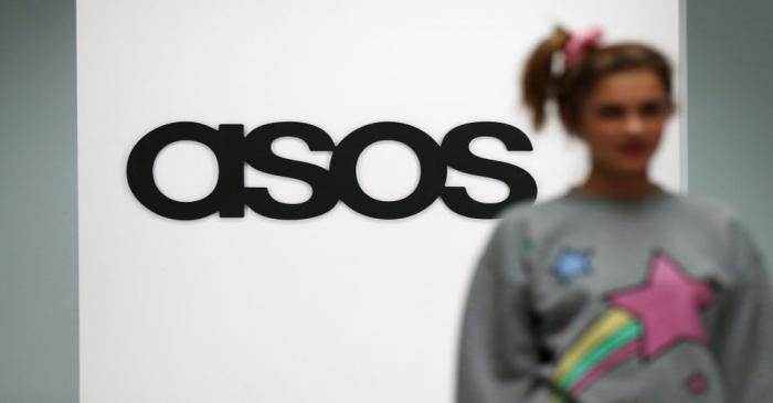 FILE PHOTO: A model walks on an in-house catwalk at the ASOS headquarters in London