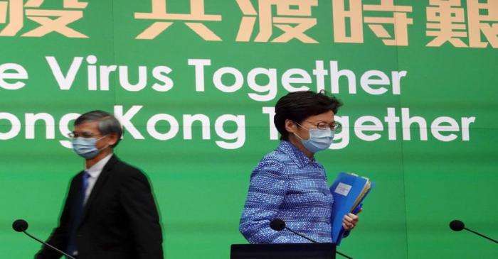 Hong Kong Chief Executive Carrie Lam wearing a face mask arrives for a news conference in Hong